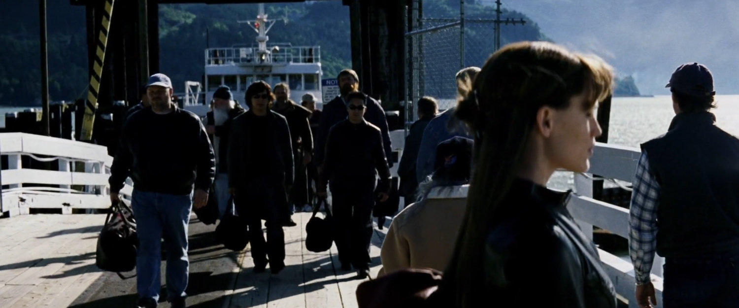 Elektra waiting on pier as people disembark from ferry.