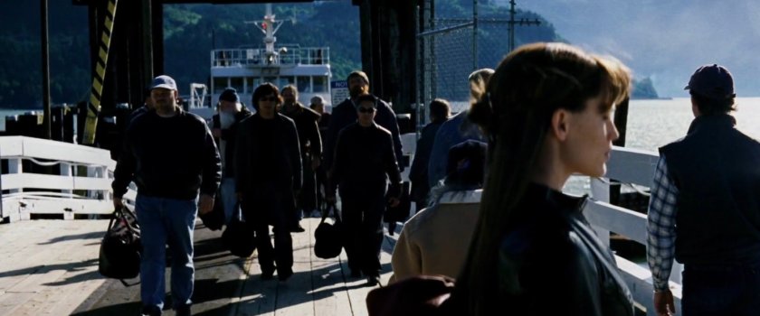 Elektra waiting on pier as people disembark from ferry.
