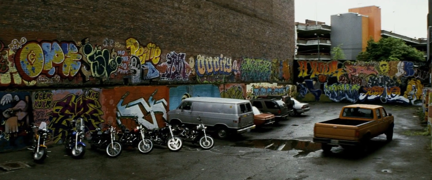 Graffiti'd parking lot outside pool hall.