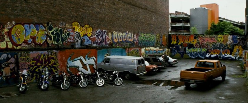 Graffiti'd parking lot outside pool hall.