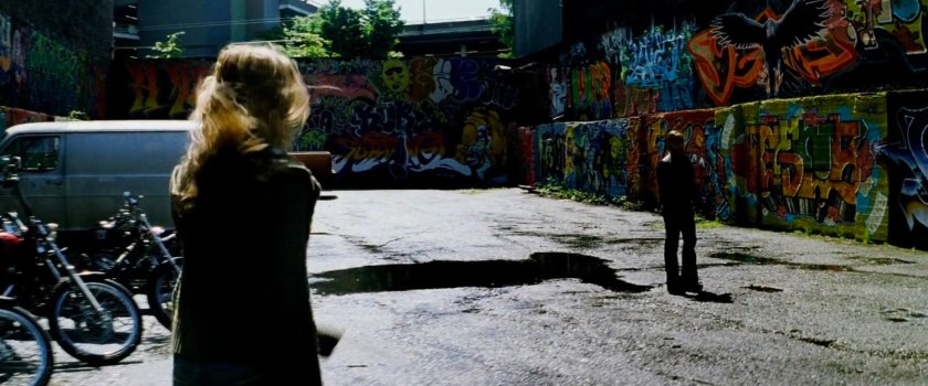 Elektra and Abby in graffiti'd parking lot outside pool hall.