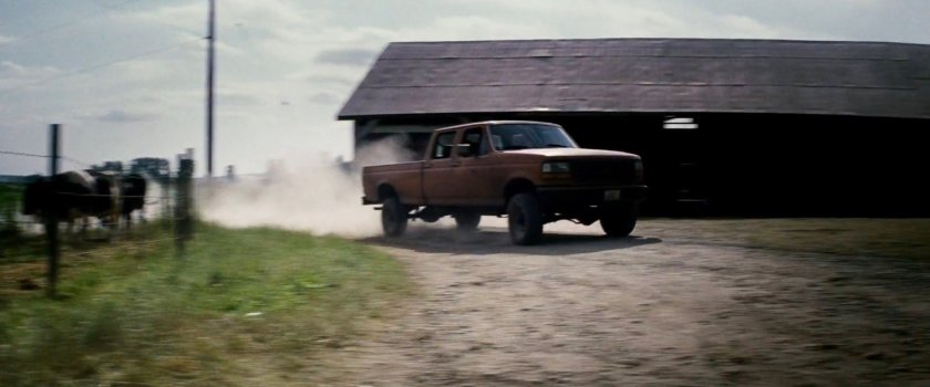 Pickup truck pulling into the McCabe farm driveway.