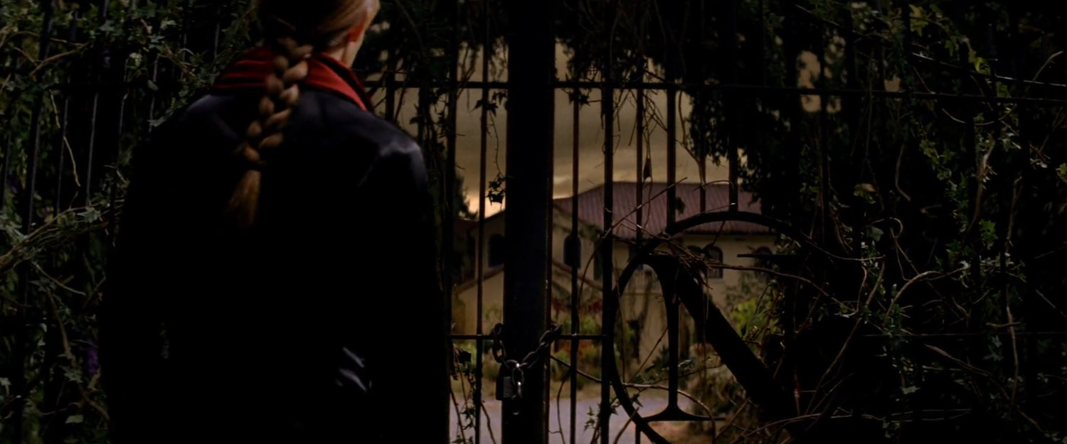 Elektra outside the gates of the Natchios mansion.