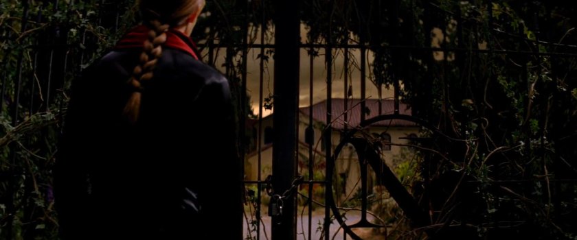 Elektra outside the gates of the Natchios mansion.