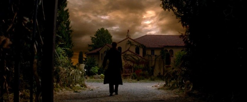 Elektra walking towards the Natchios mansion.