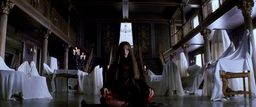 Elektra sitting in main front room of the Natchios mansion.