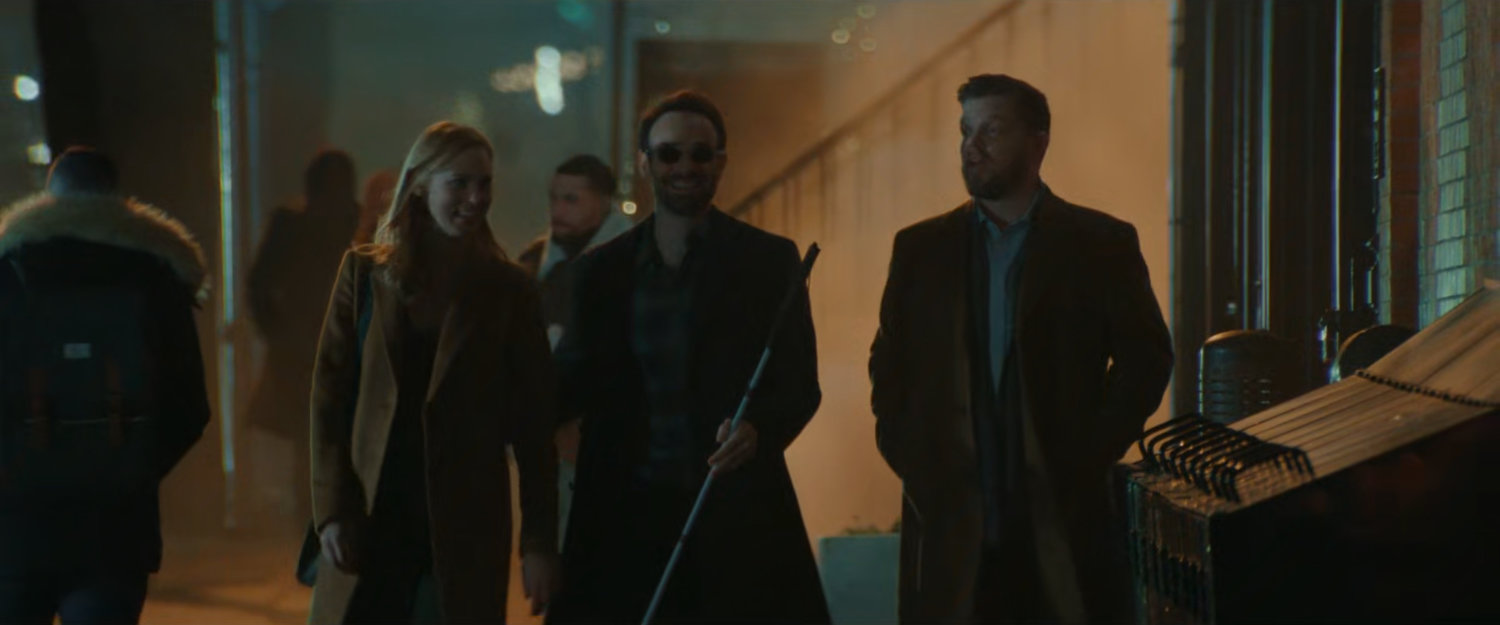 Karen, Matt, and Foggy on the sidewalk at night.