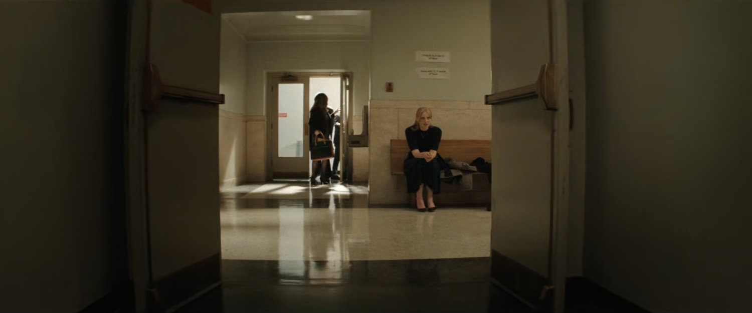 Karen sitting in the hallway outside the court.