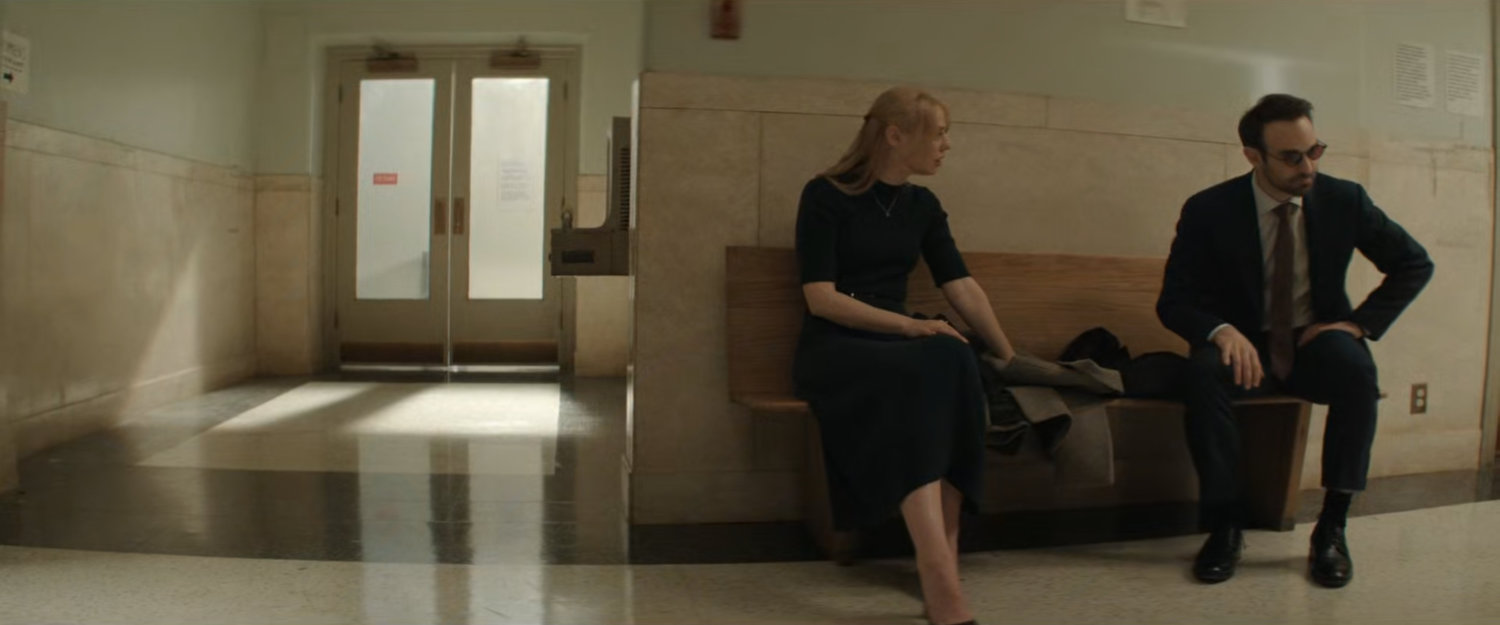 Karen and Matt sitting in the hallway outside the court.