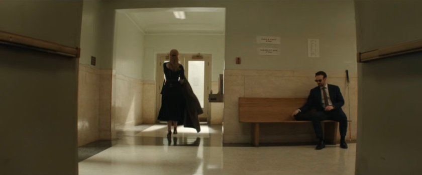 Karen walking away from Matt in the hallway outside the court.