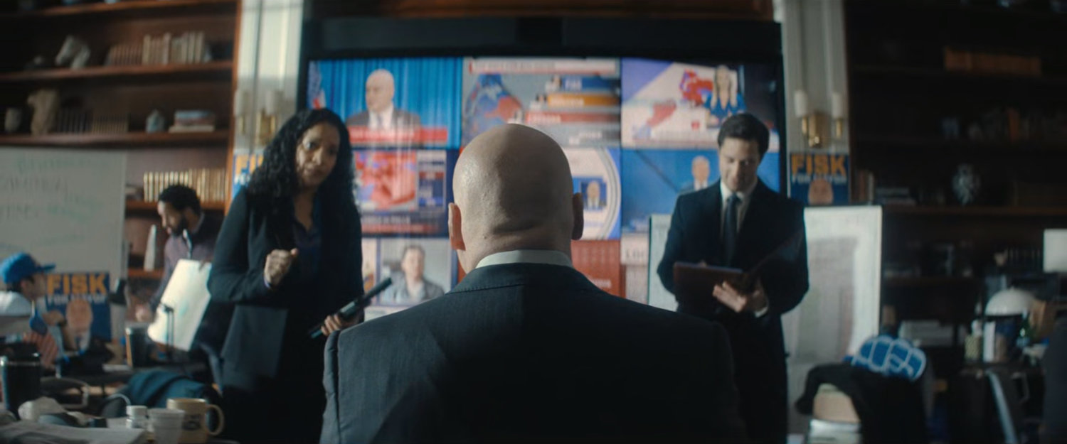 Fisk in front of a video wall at his campaign headquarters.