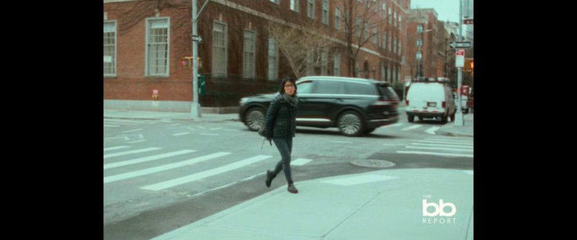 BB Report: woman on street corner.