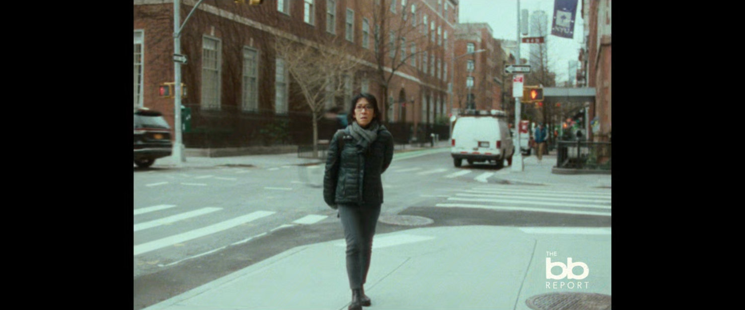 BB Report: woman on street corner.
