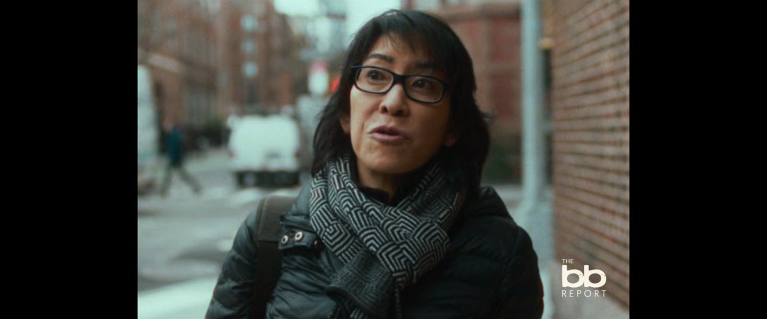 BB Report: woman on street corner.