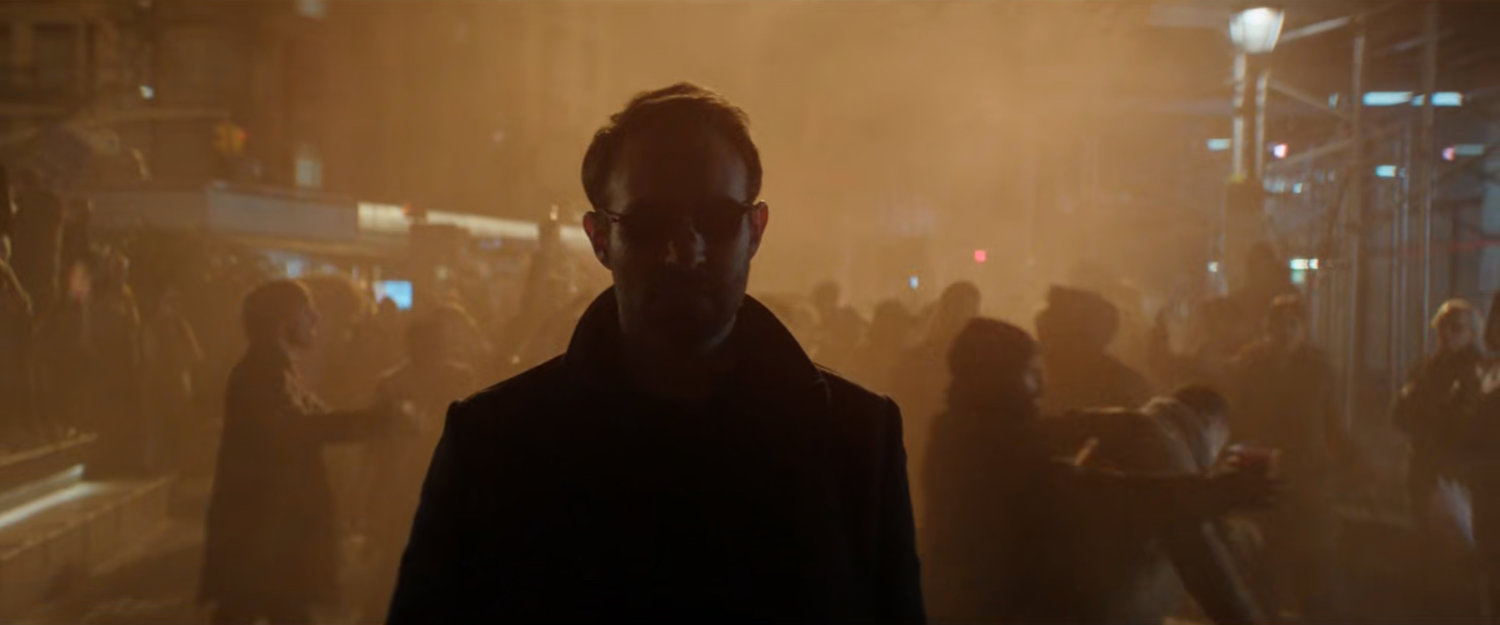 Matt on a smoky street with celebrating pedestrians behind him.