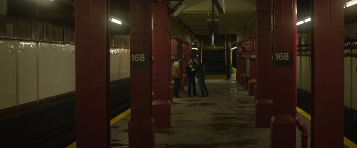 Two men accost a third man in the 168 Subway Station.