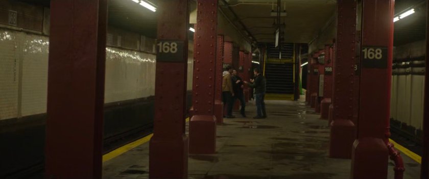 Two men accost a third man in the 168 Subway Station.