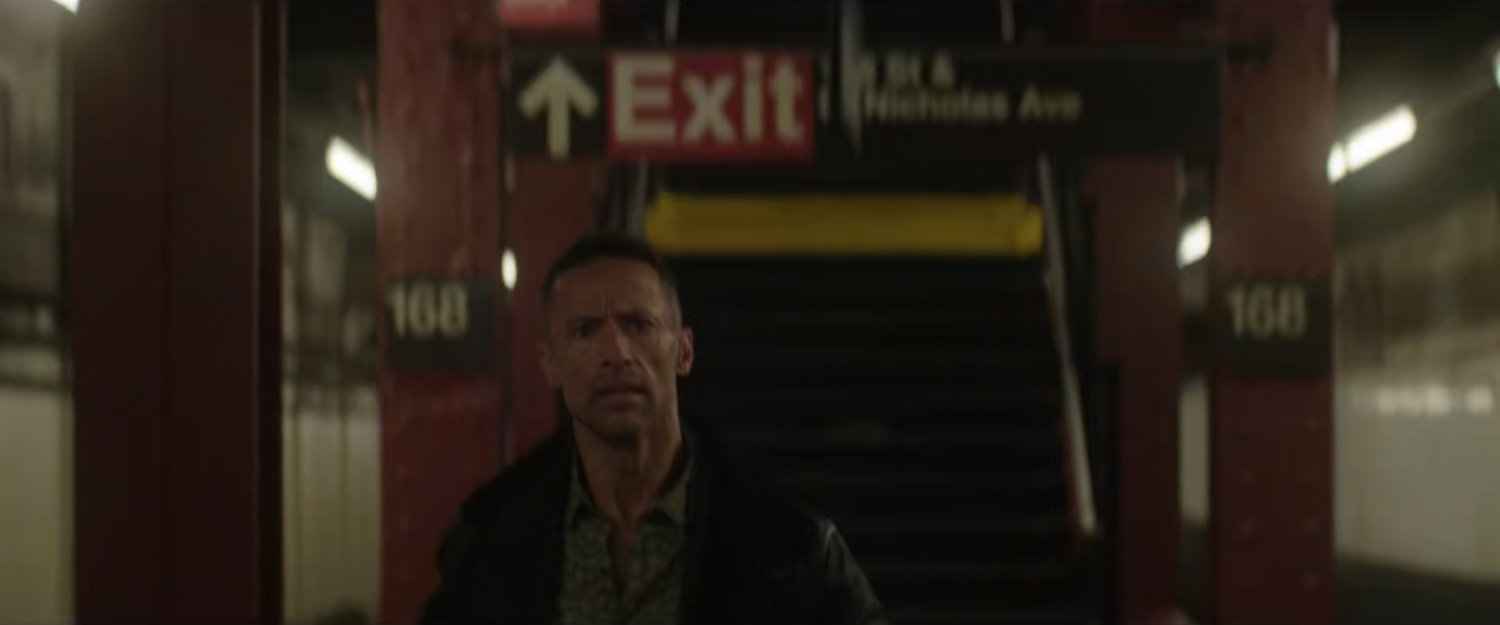 Hector walking across platform in the 168 Subway Station.