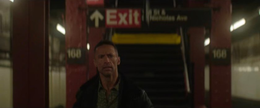 Hector walking across platform in the 168 Subway Station.