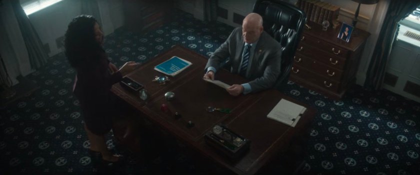 Fisk at his desk in City Hall talking with Sheila.