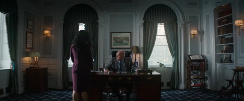 Fisk sitting at his desk in City Hall talking to Sheila.