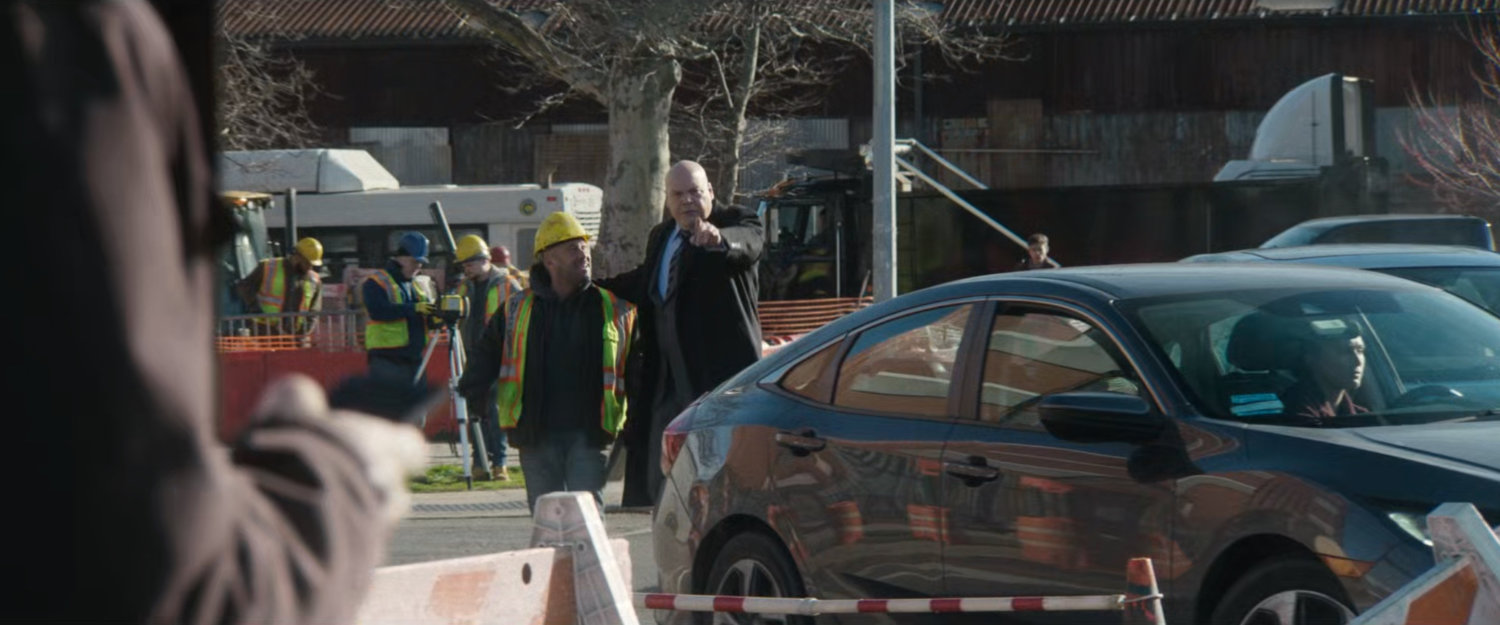 Mayor Fisk directs a city worker to fill the sizable pothole.