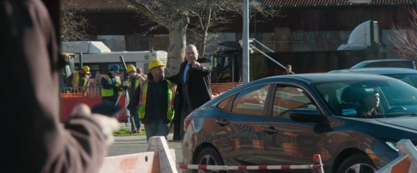 Mayor Fisk directs a city worker to fill the sizeable pothole.