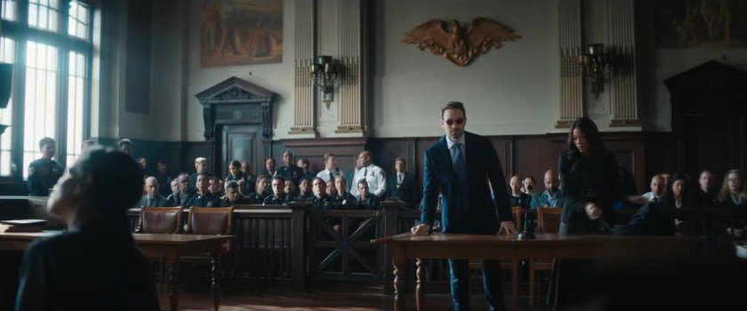 Matt and Kirsten in a courtroom with dozens of police officers.