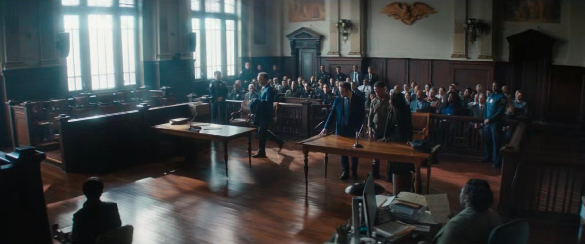 Wide shot of a courtroom with Matt and Kirsten defending Hector Ayala.