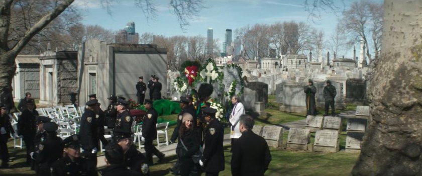Police officers gathered at cemetery for officer's funeral.