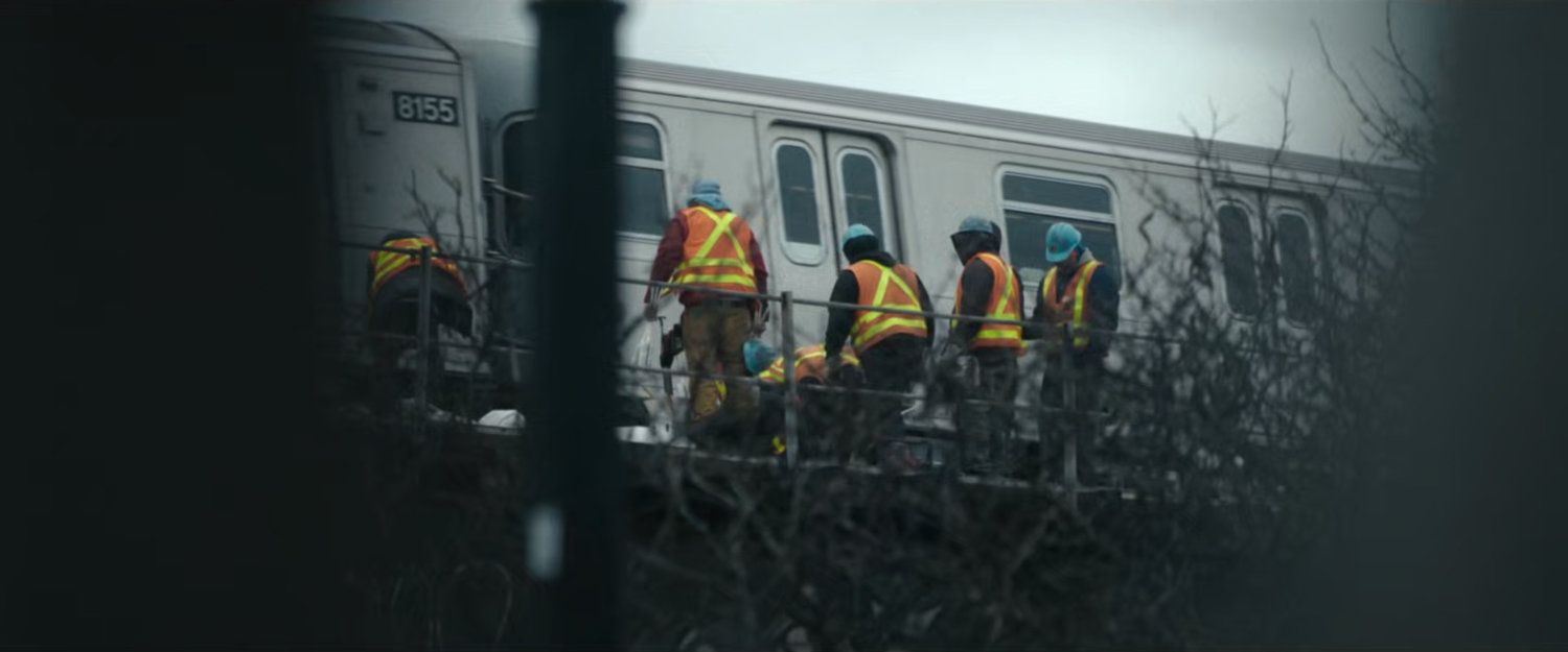 Interstitial: workers by elevated Metro train.