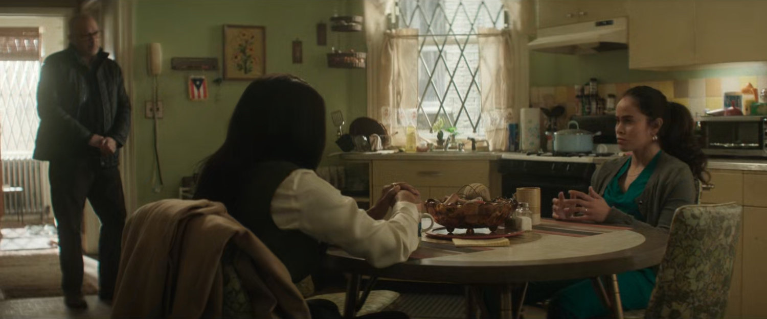 Soledad Ayala in her kitchen talking to Kirsten as Cherry listens.
