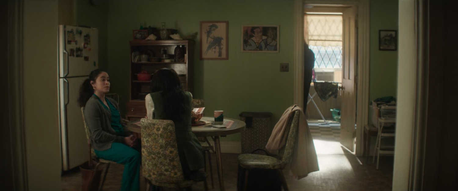 Soledad Ayala in her kitchen talking to Kirsten as Cherry enter bedroom.