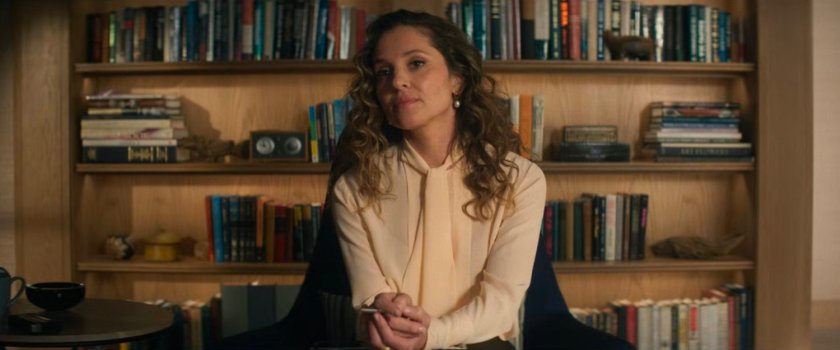 Heather in front of a bookshelf in her office.