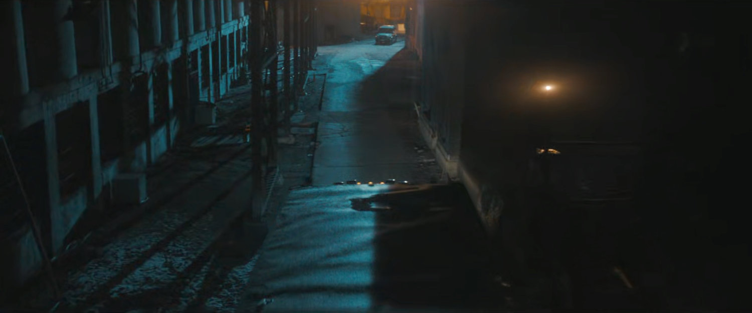 A truck in a dark alley at Red Hook port.