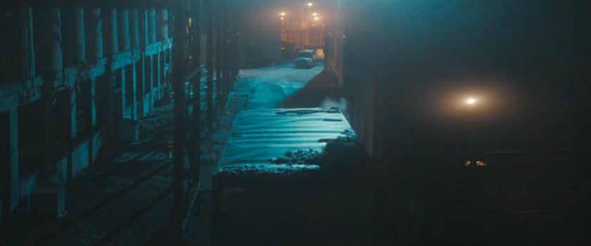 A truck in a dark alley at Red Hook port.