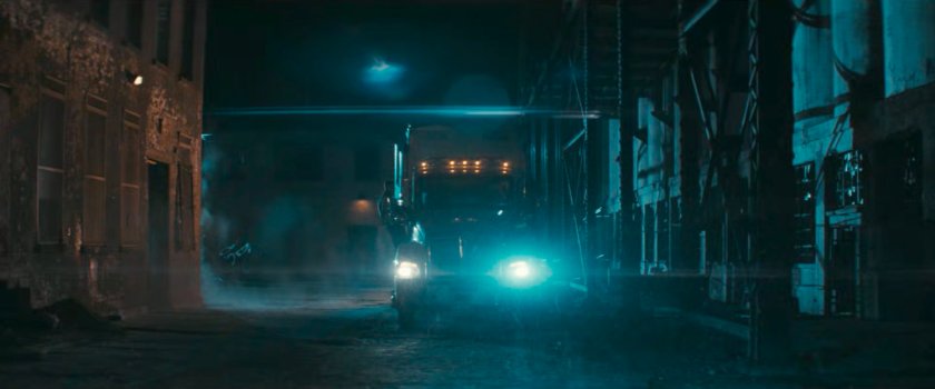 A truck in a dark alley at Red Hook port.