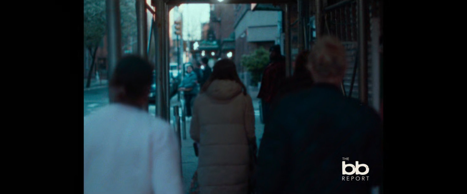 BB Report: people walking on sidewalk under construction overhang.