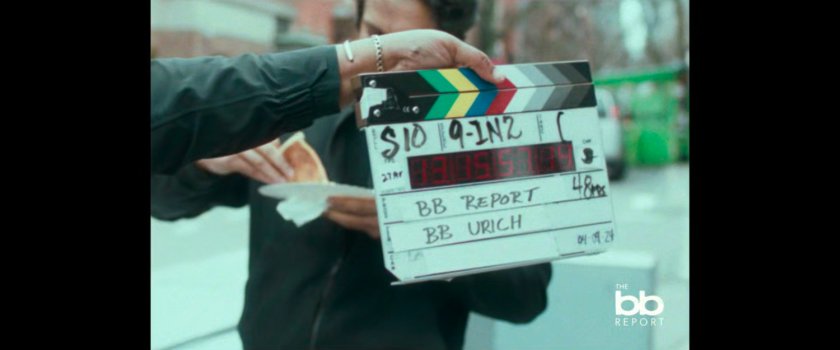 BB Report: slate in front of man eating pizza.