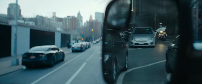 Cherry's POV in mirror of cars following his van.