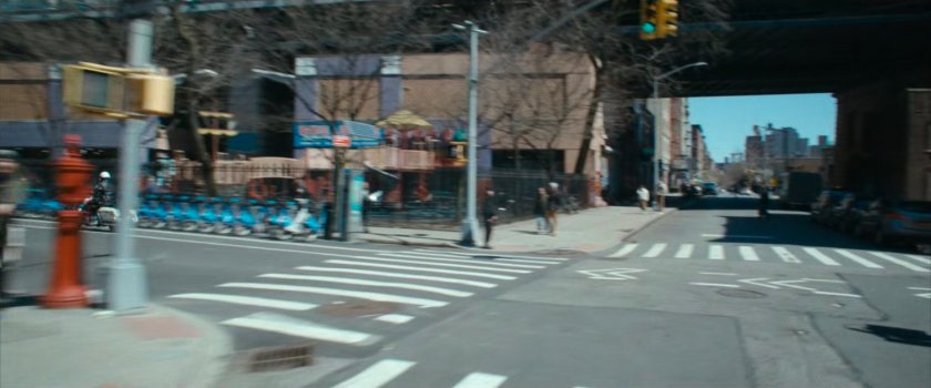 Motorcycle officer speeding past intersection.