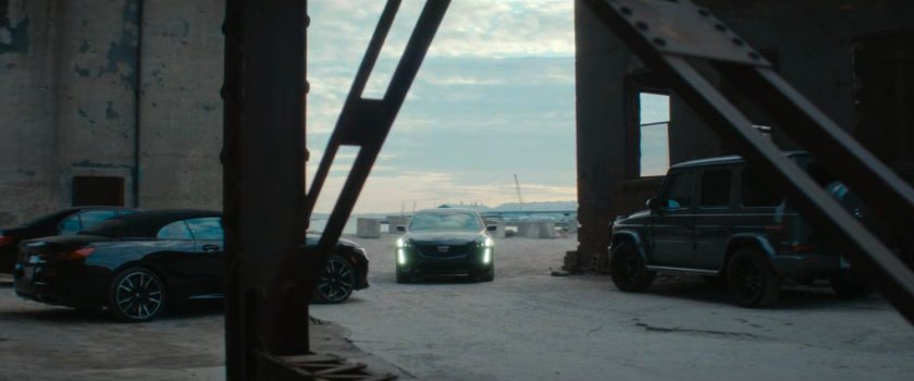 Car pulls up outside exterior of abandoned grain terminal.