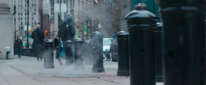 Interstitial: black bollards along a sidewalk.