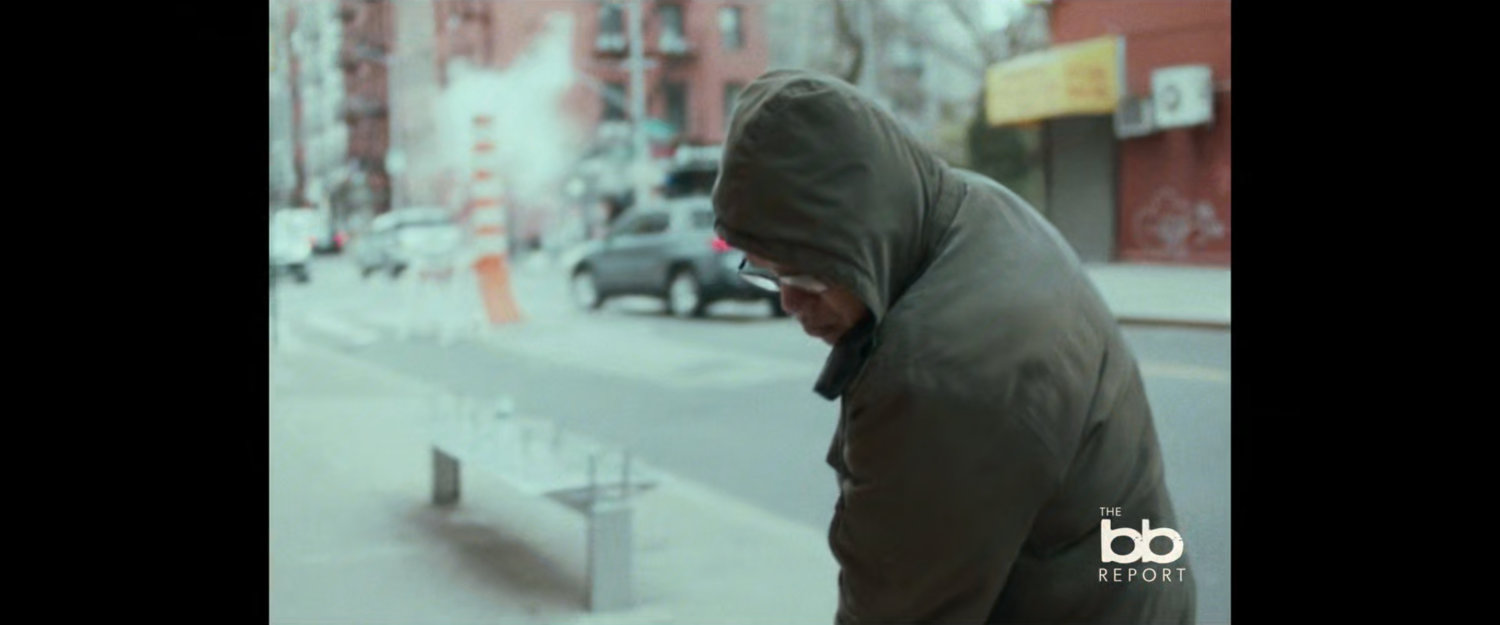 BB Report: man sweeping sidewalk.