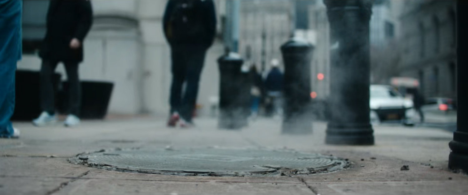Interstitial: closeup of steaming manhole.