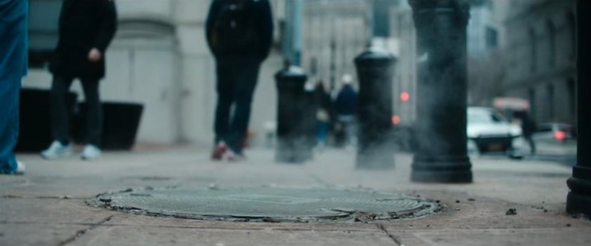 Interstitial: closeup of steaming manhole.