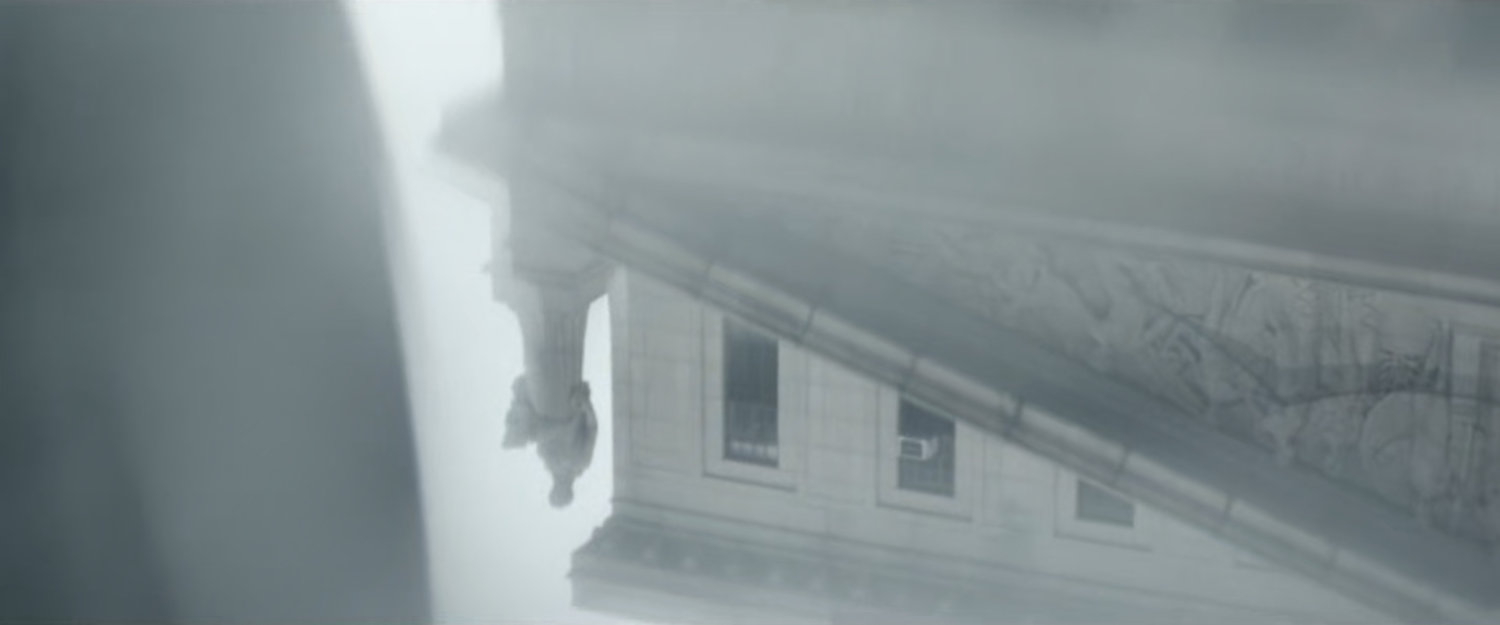 Interstitial: reflection of courthouse statue in puddle.