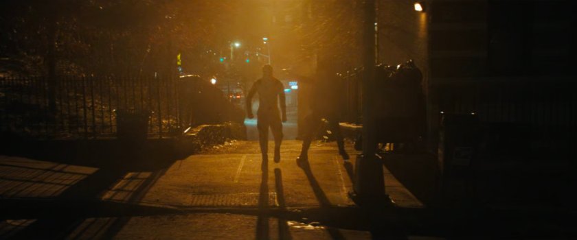 Stranger stepping out towards White Tiger with gun.