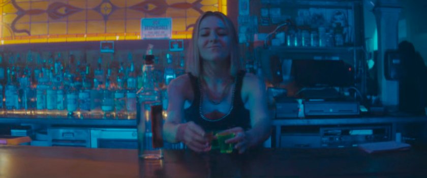 Bartender at club picking up shots.