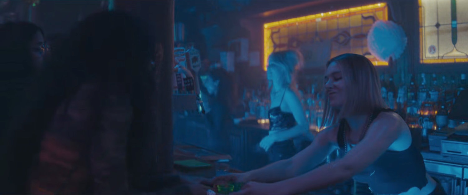 Bartender at club serving shots.